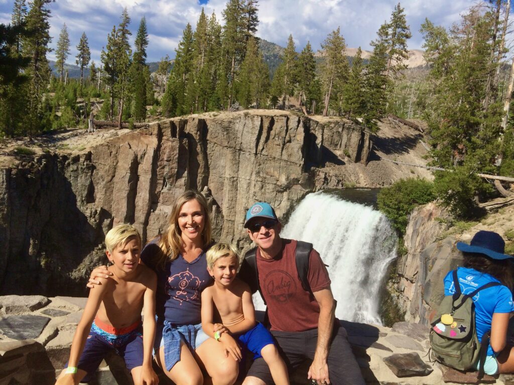 family in front of waterfall