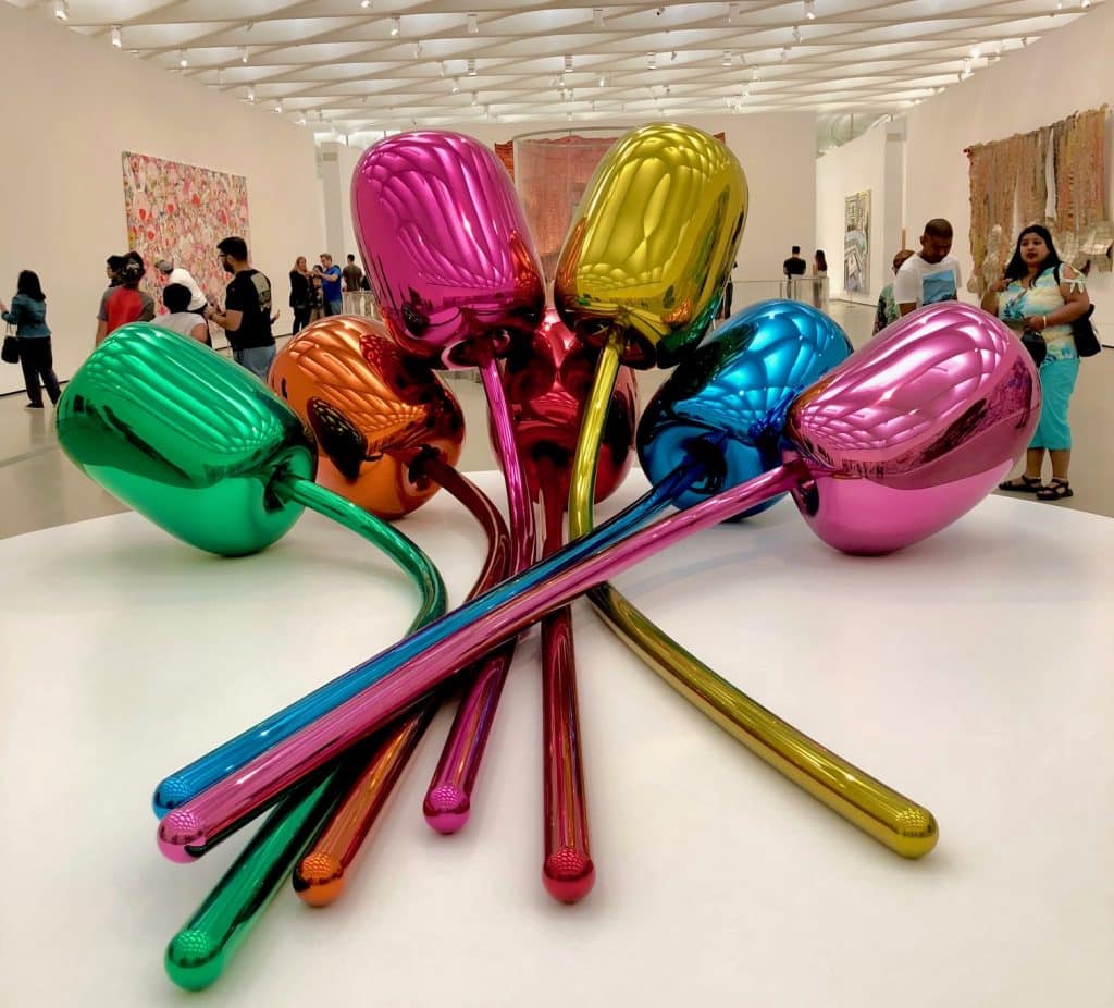 Vibrant, colorful contemporary sculpture displayed inside The Broad Museum in Los Angeles, set against the museum’s minimalist interior