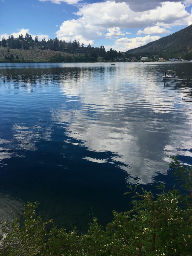 placid lake with clouds reflected in water