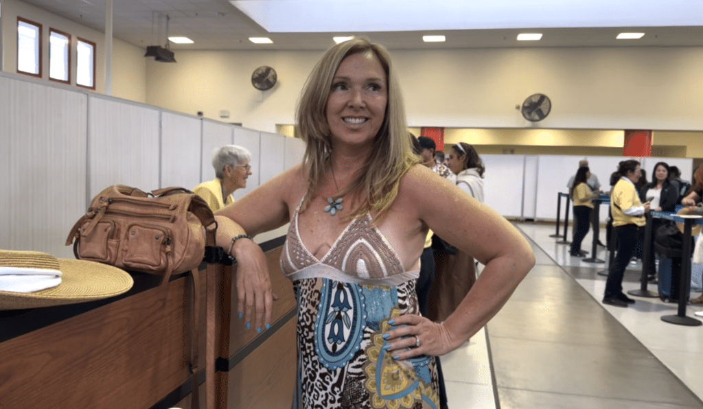 woman standing to check in for her cruise from Los Angeles