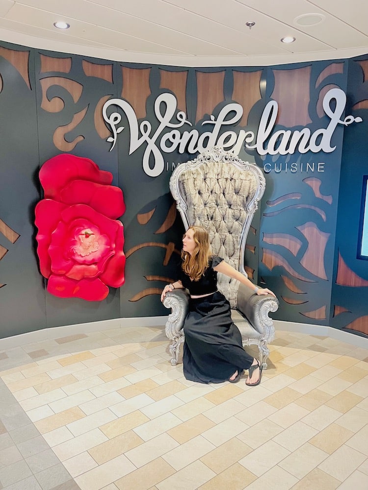 woman sitting on chair in front of Wonderland restaurant