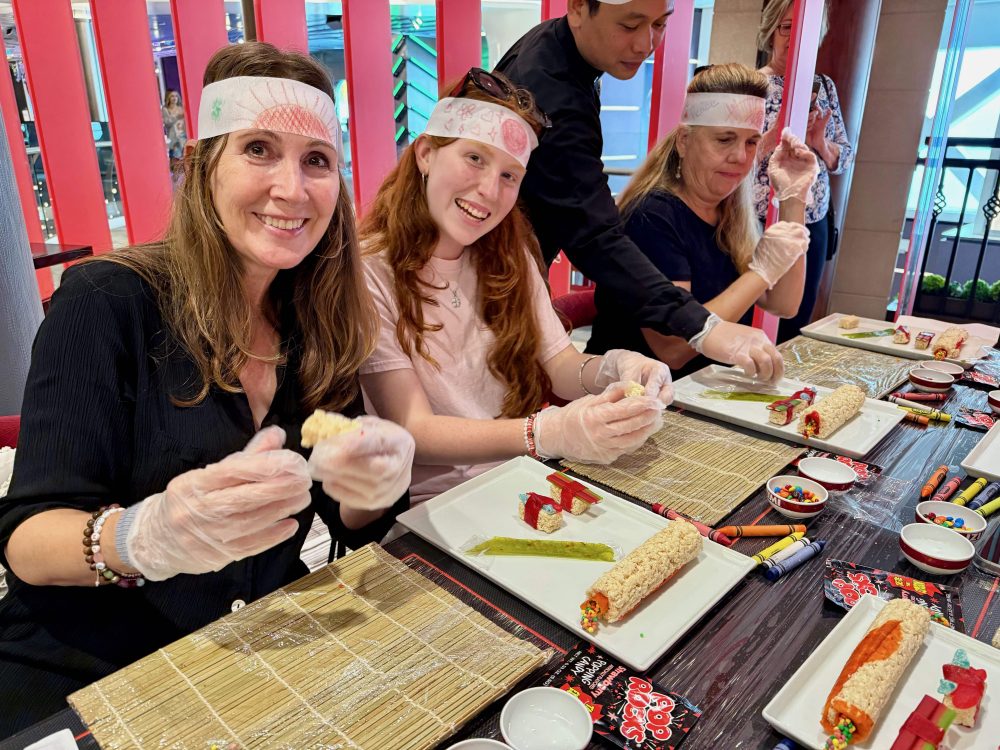 A mom and daughter making sushi candy
