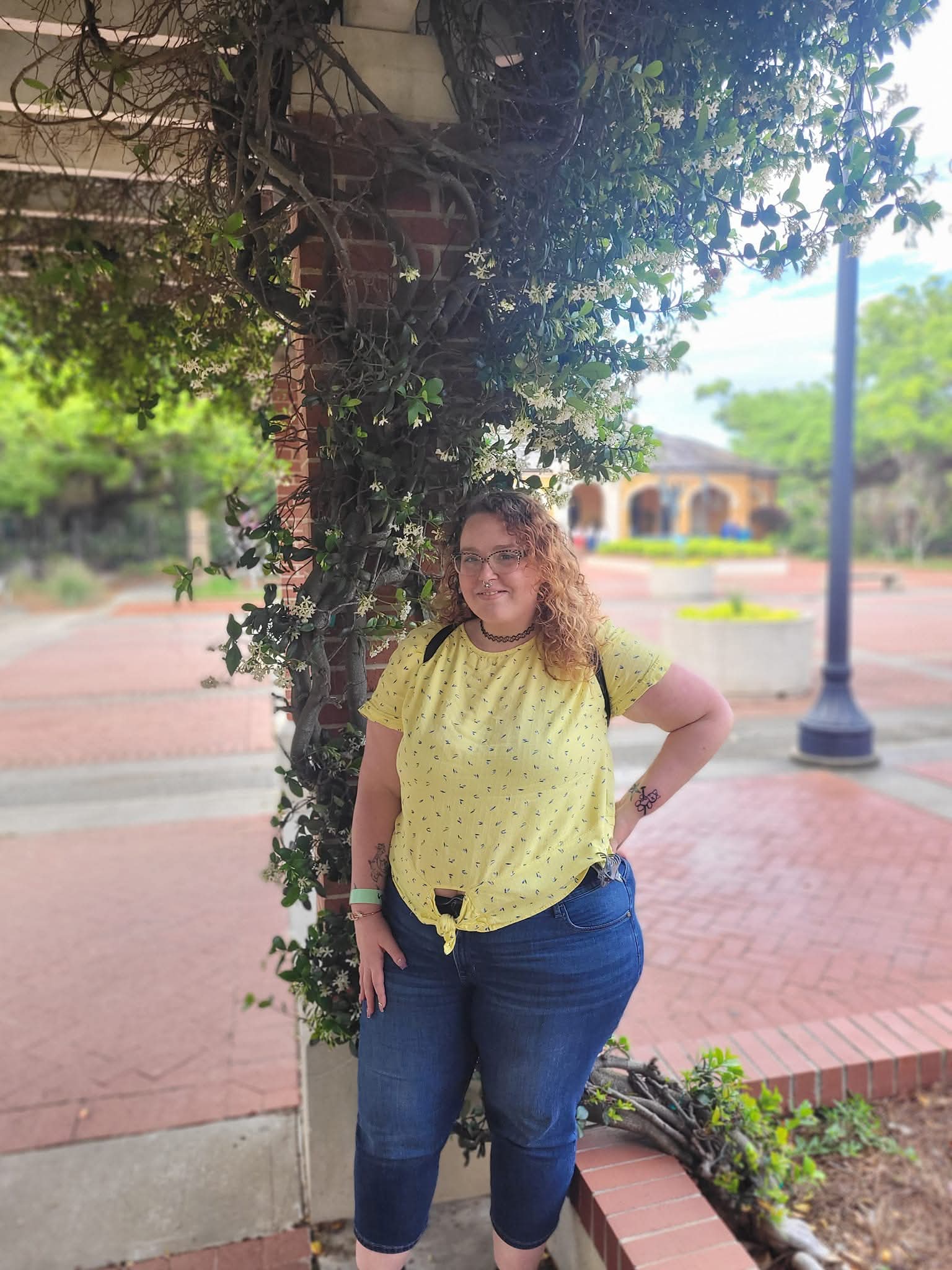 Woman standing in front of flowers at New Orleans Botanical Garden. Affordable places to go for spring break. 
