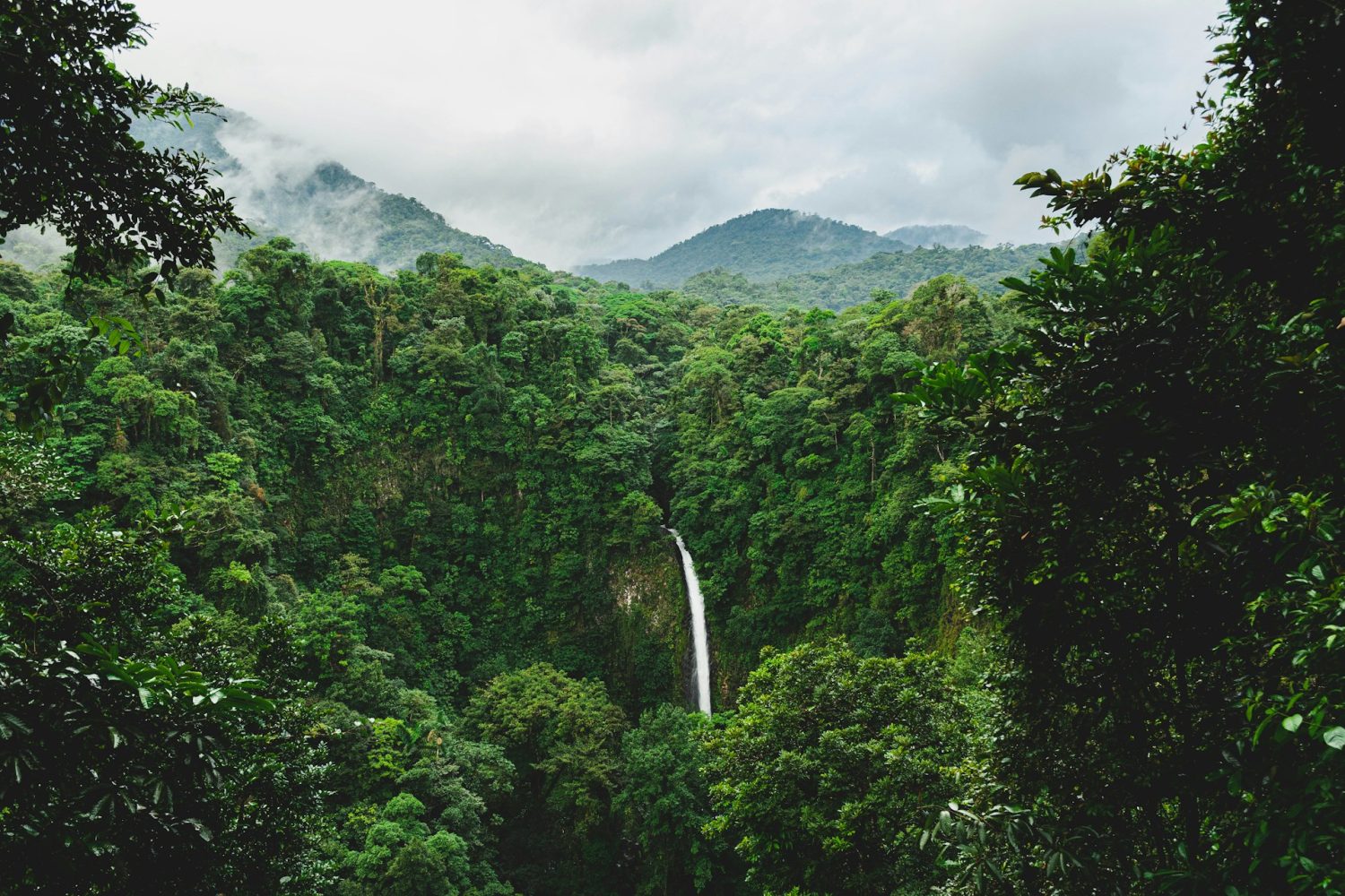 Waterfall in La Fortuna's lush forests. Affordable places to go for spring break. 