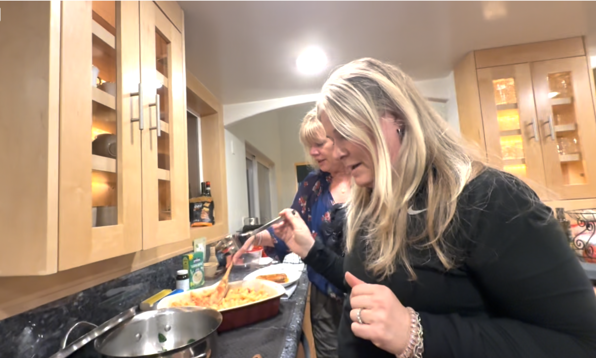 women preparing dinner is huge kitchen