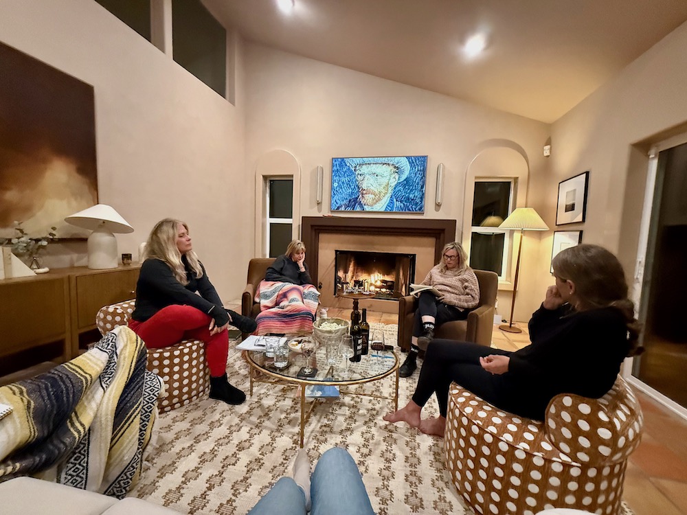 women in living room chairs by fireplace