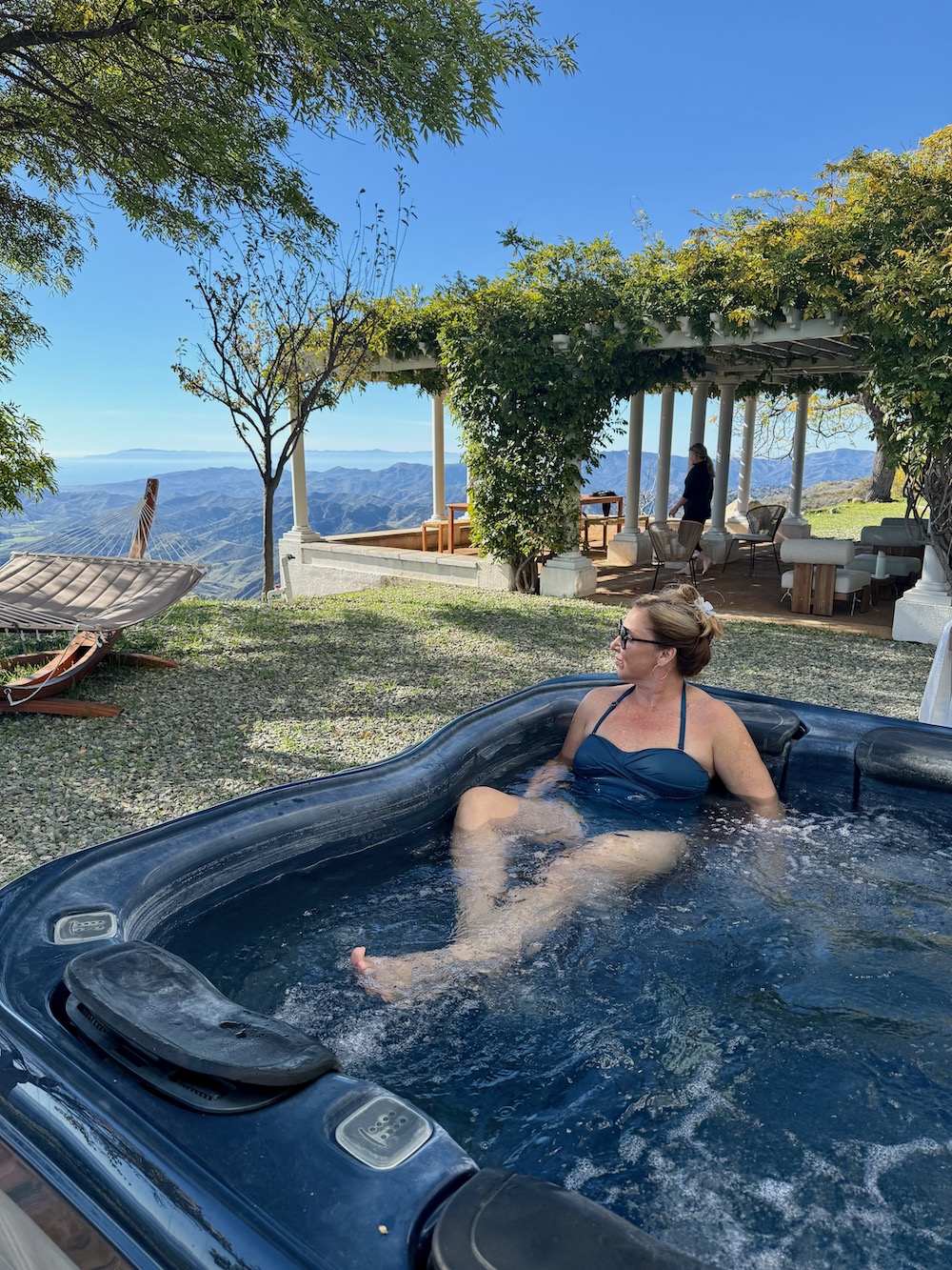 woman in hot tub with mountain view