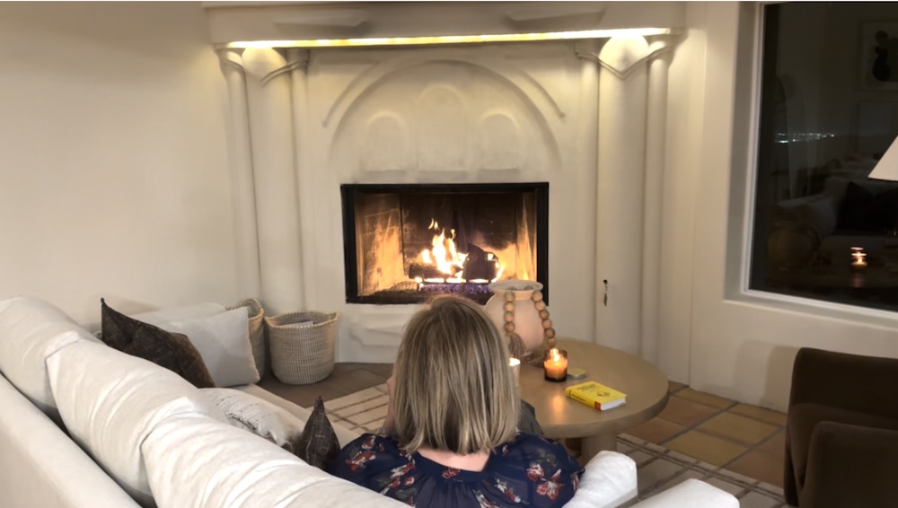woman in front of fireplace