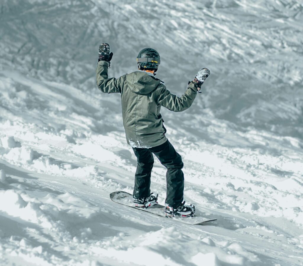 Snowboarder going down the mountain. 