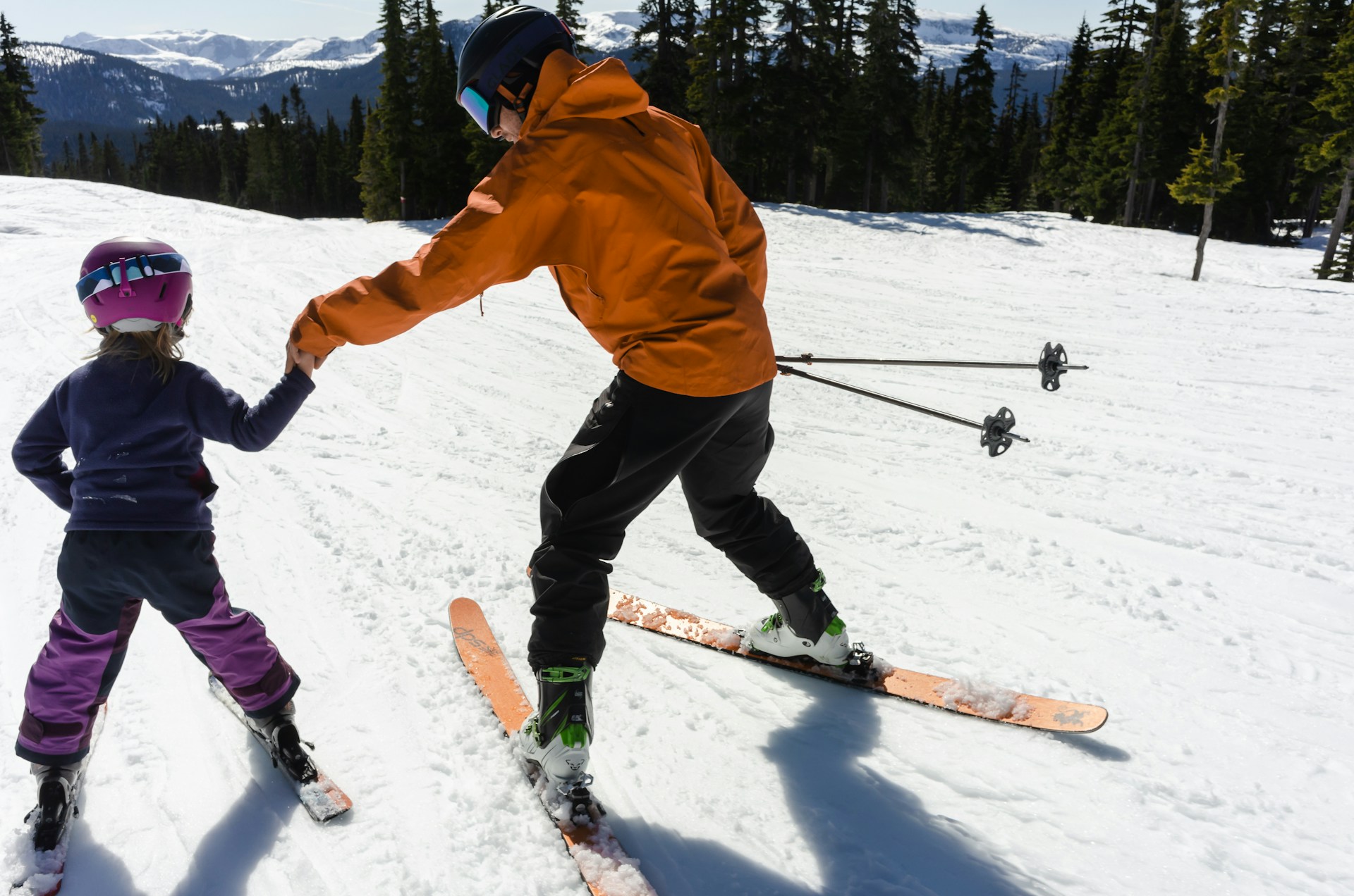 man skiing with child