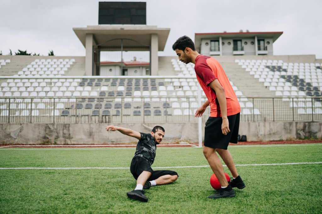 two men playing soccer in stadium