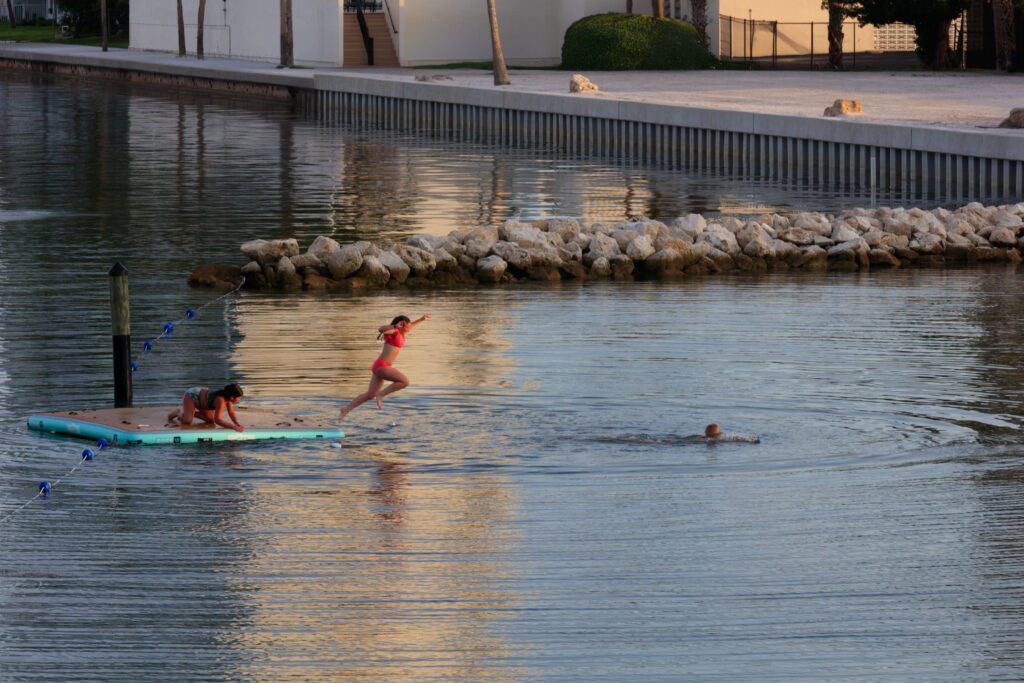 kids jumping into lake