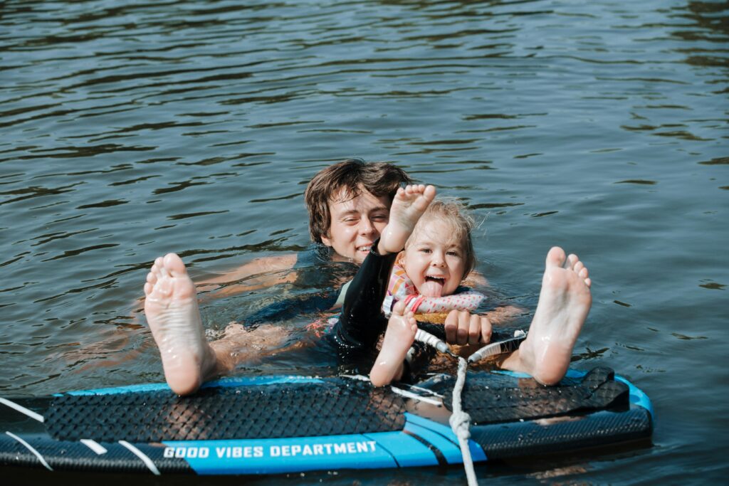 two kids in water getting ready to wakeboard on California Boating Lakes