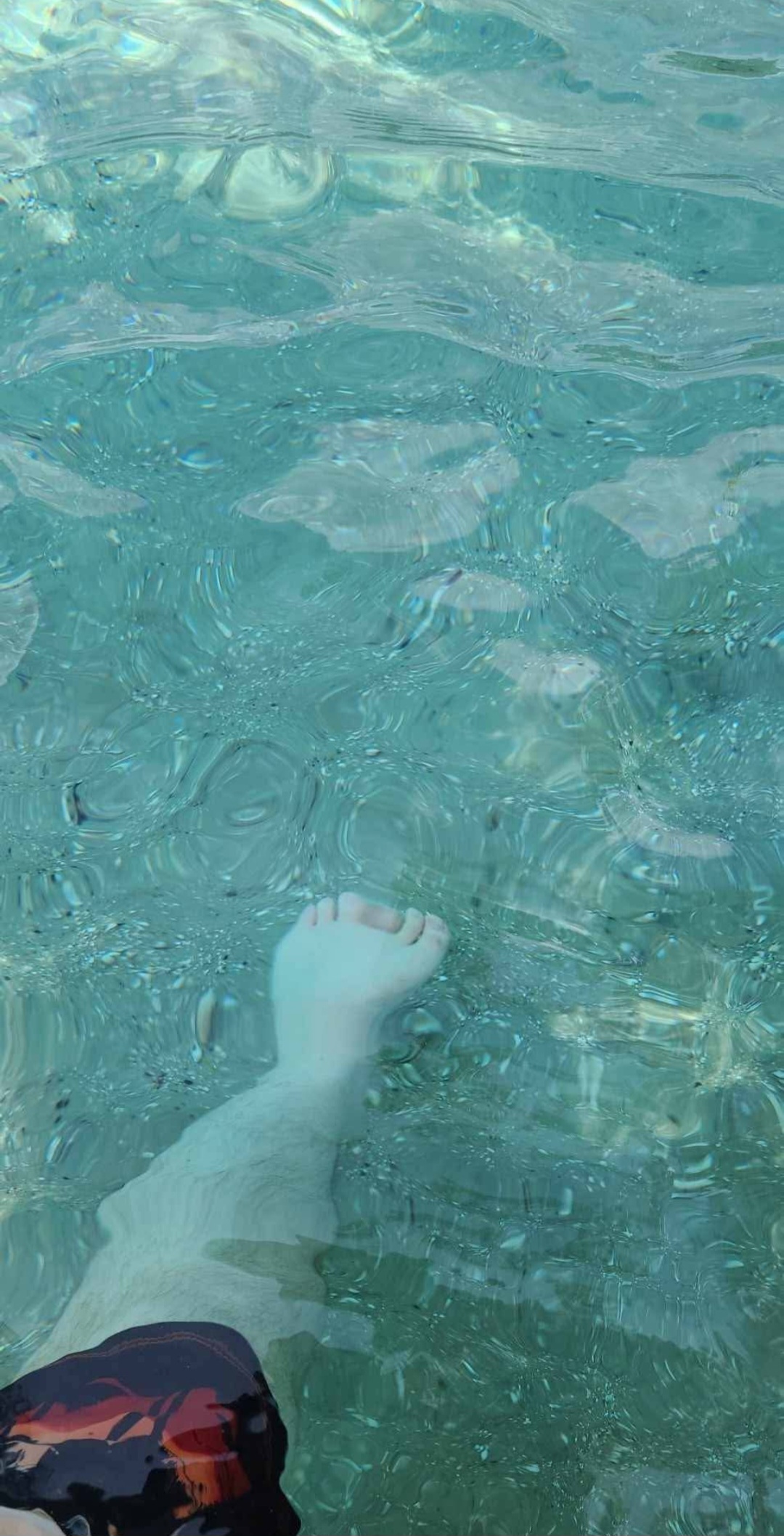 Man's foot at the bottom of crystal clear spring water. Hot springs in Florida. Best natural springs. 