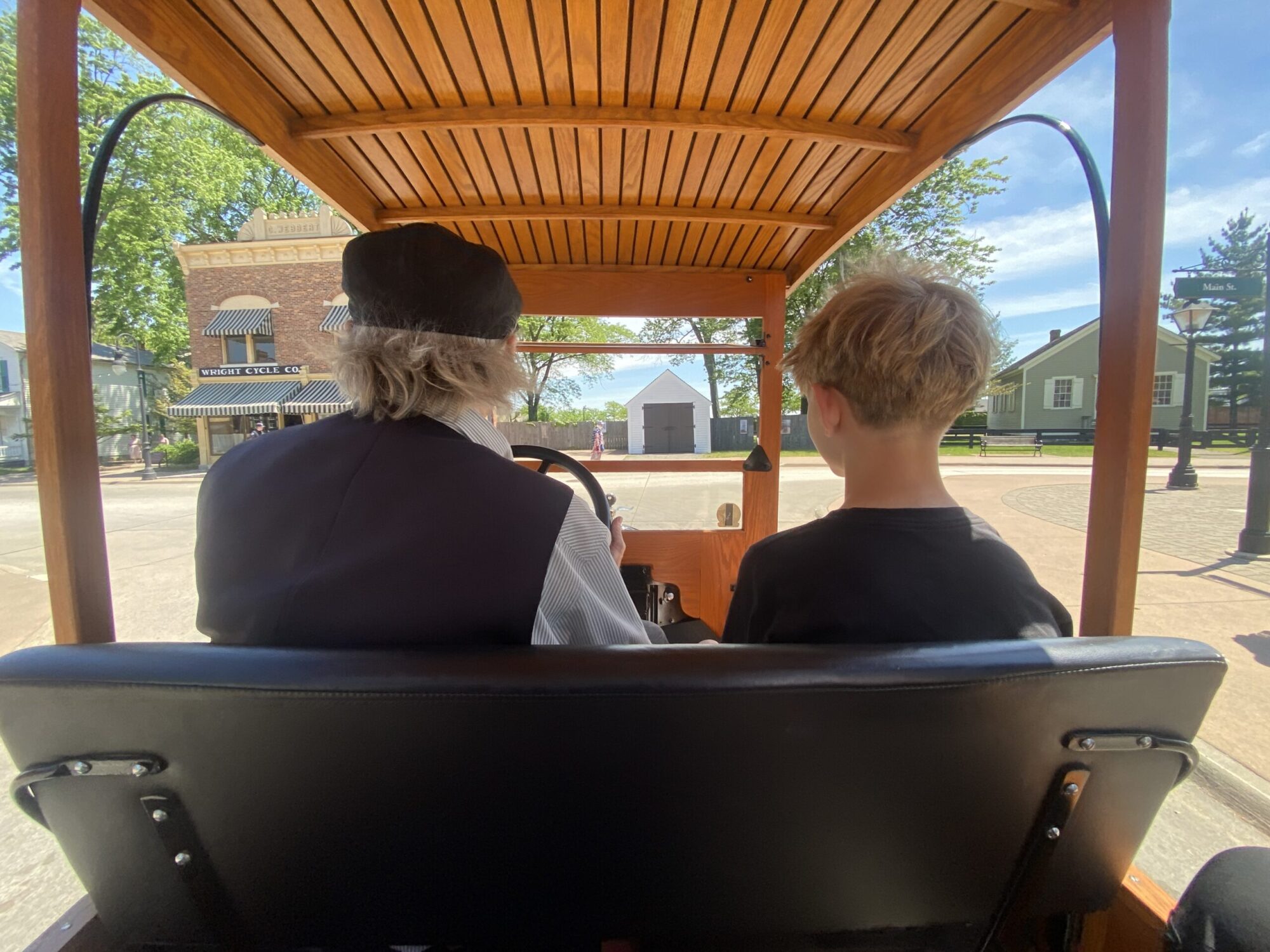 boy riding with museum docent on Model T