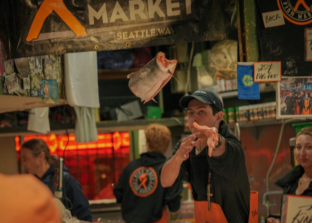 Fish workers throwing fish at Pike Place Market.