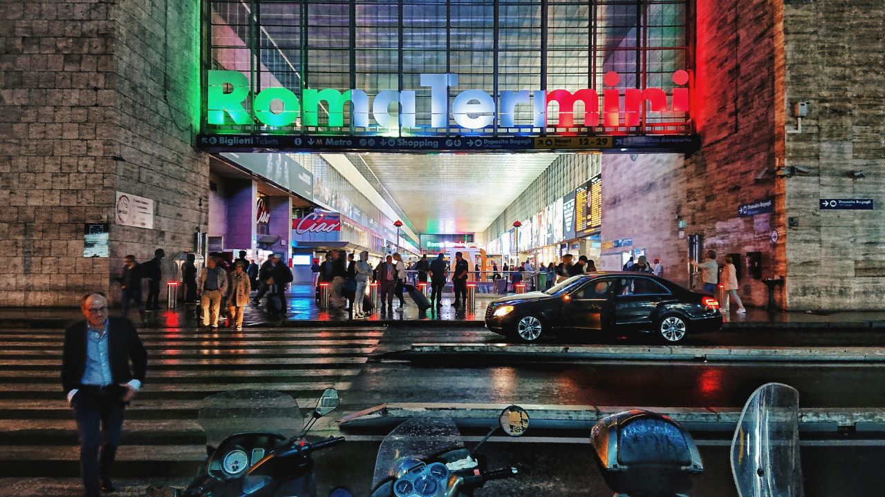 Roma Termini with a sign that's lit up at the entrance