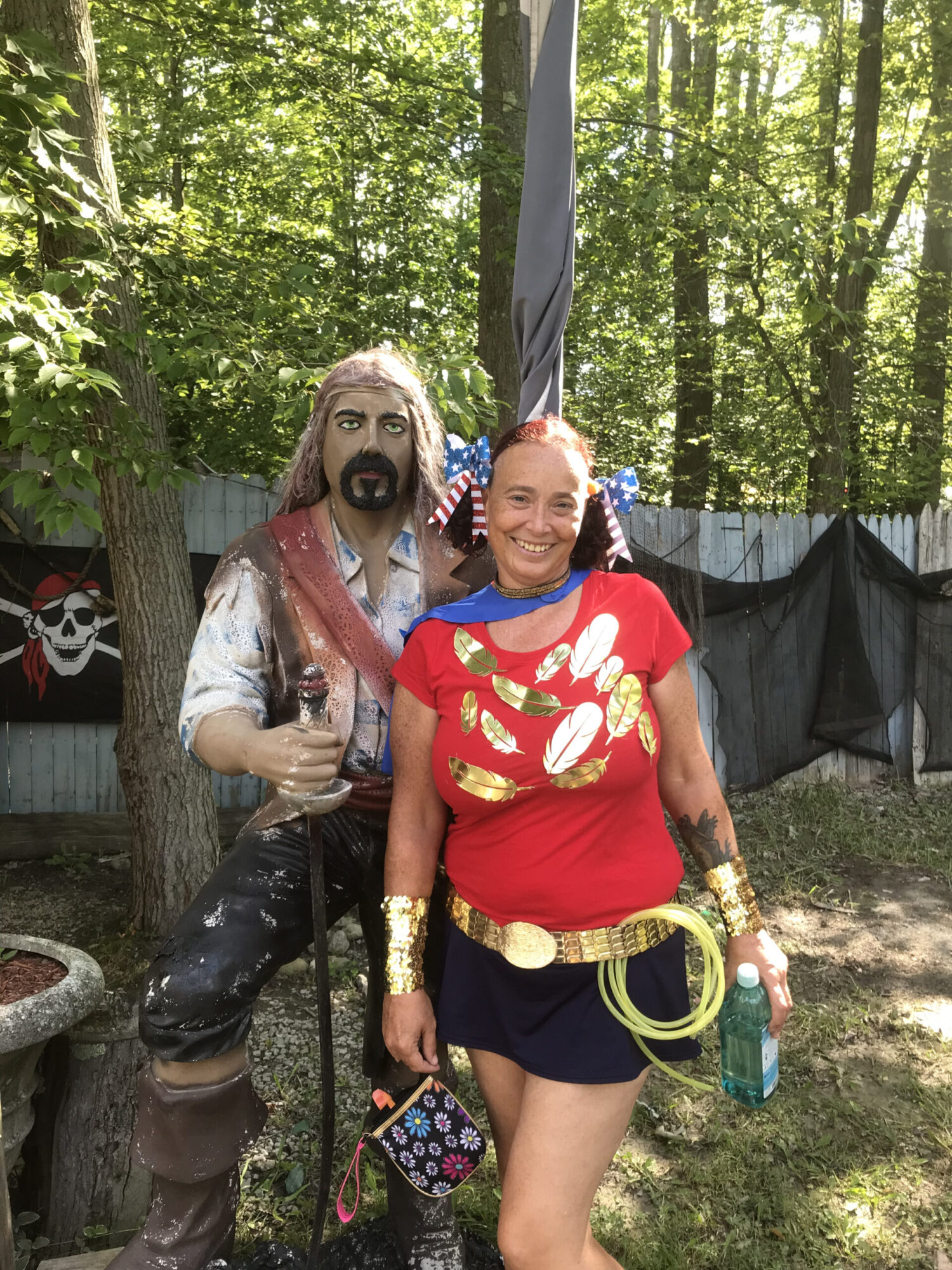 Woman dressed as superhero next to medieval figure at the Great Lakes Medieval Faire.