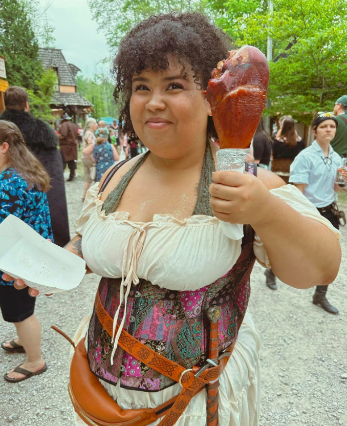Woman holding giant turkey leg at the Great Lakes Medieval Faire. 
