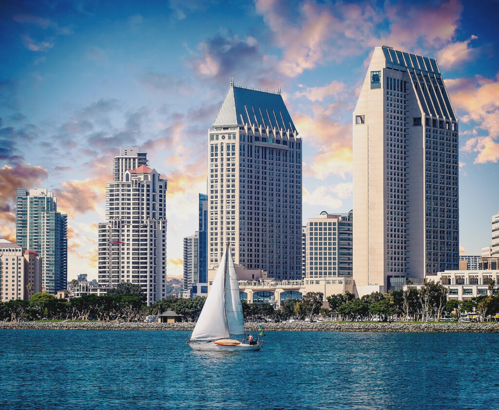 hotels behind bay with sailboat in between