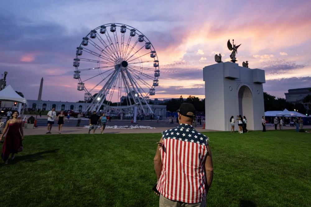 man in flag theme shirt looking at great american fair