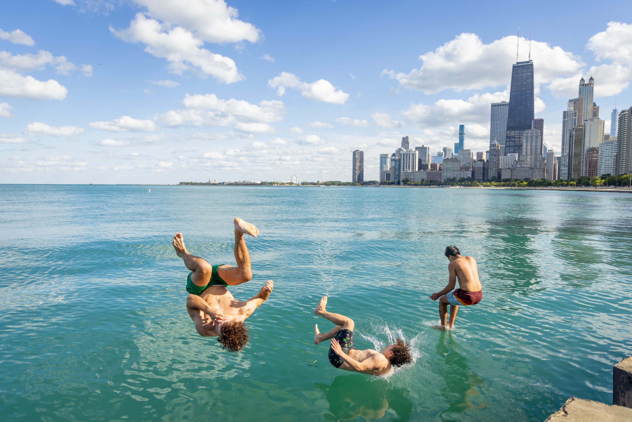 boys doing flips into water