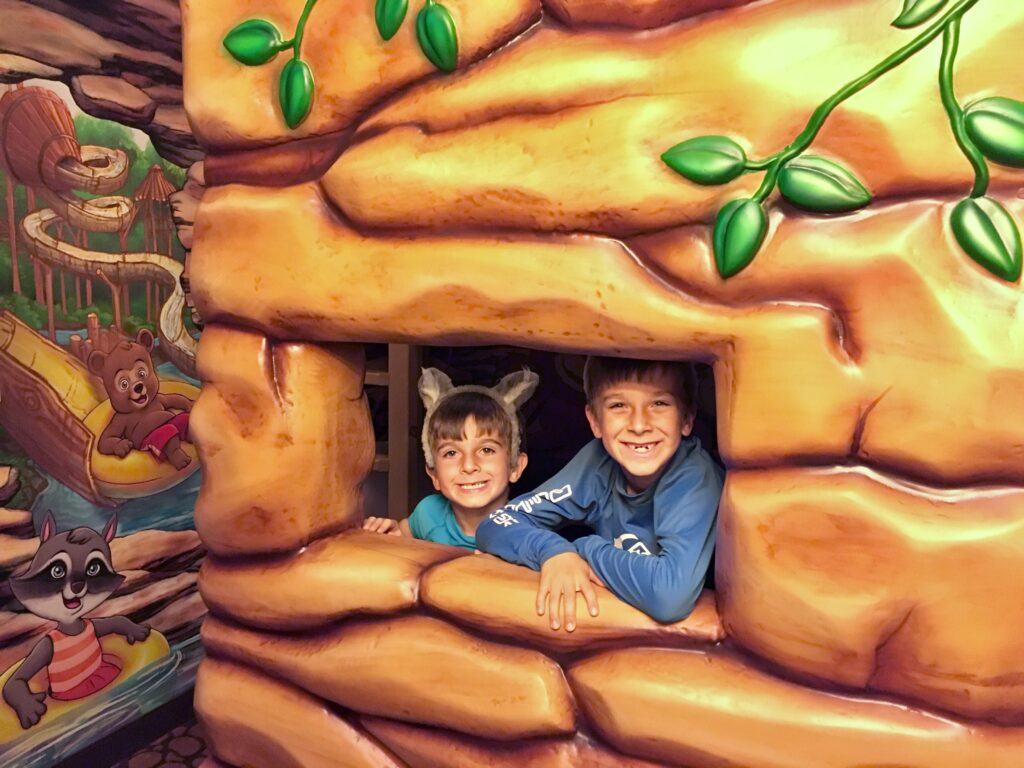 boys in wolf ears in wolf den room at the great wolf lodge