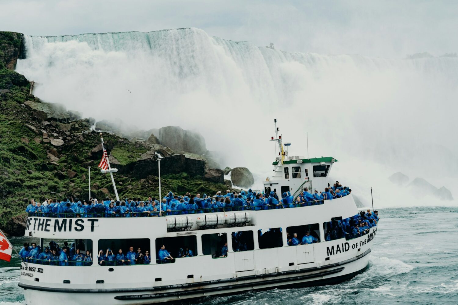 Maid of the Mist boat tour carrying passengers toward the base of Horseshoe Falls. Niagara Falls: Which Side is Better?
