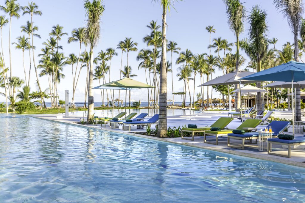 LIGHT BLUE pool with loungers and umbrellas