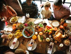 family sitting around thanksgiving table