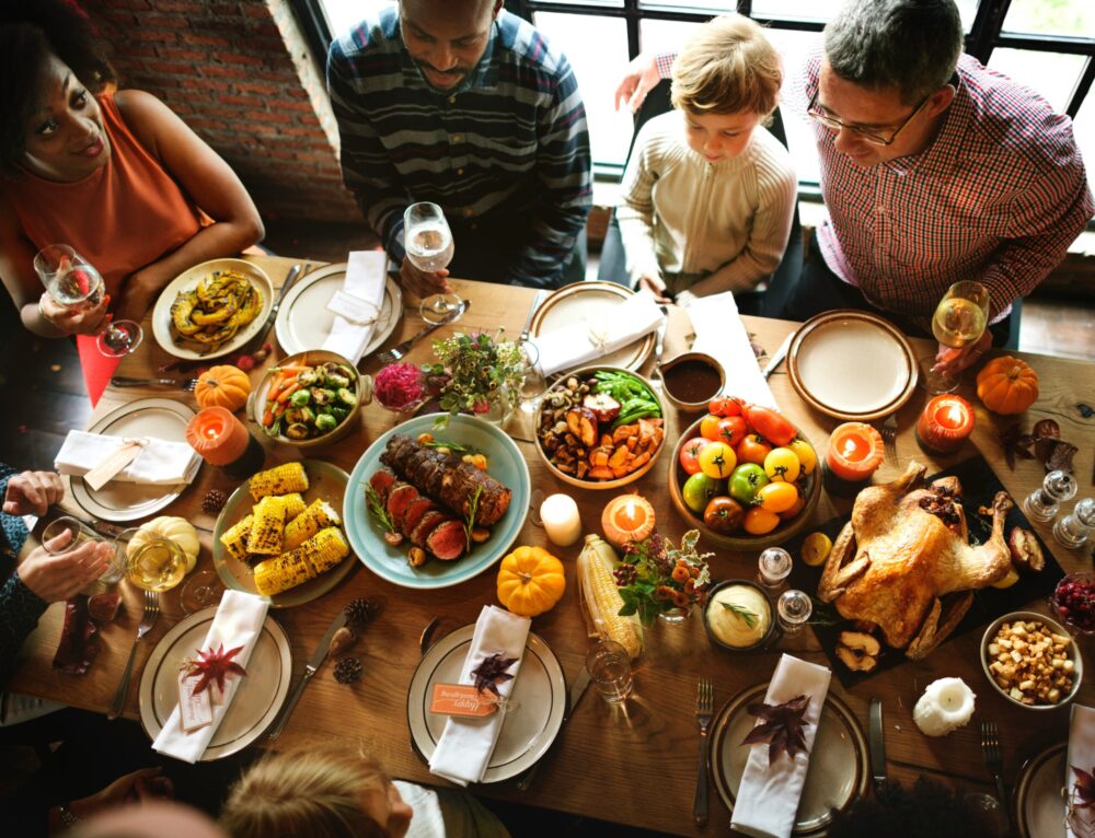 family sitting around thanksgiving table