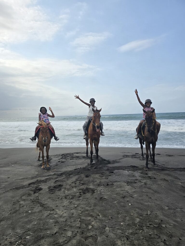 Three girls riding horses on Gianyar Beach