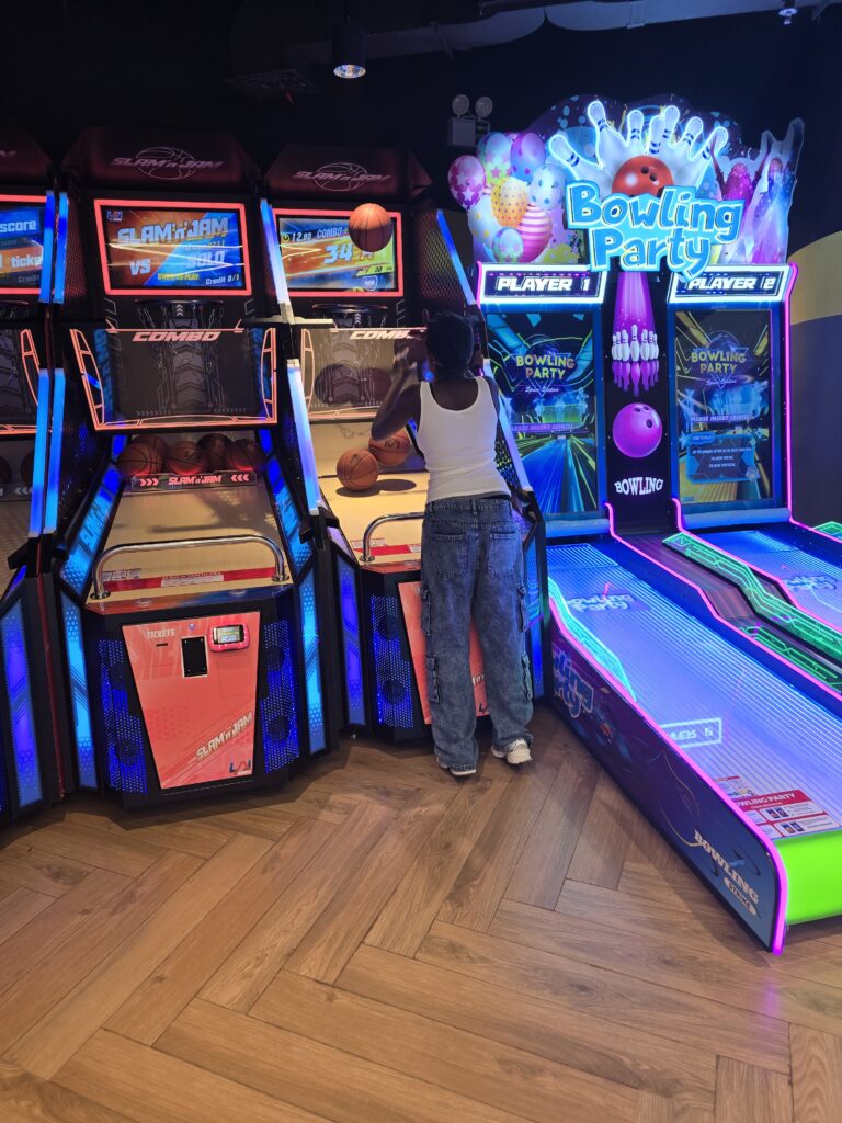 Young girl playing a basketball game at the arcade